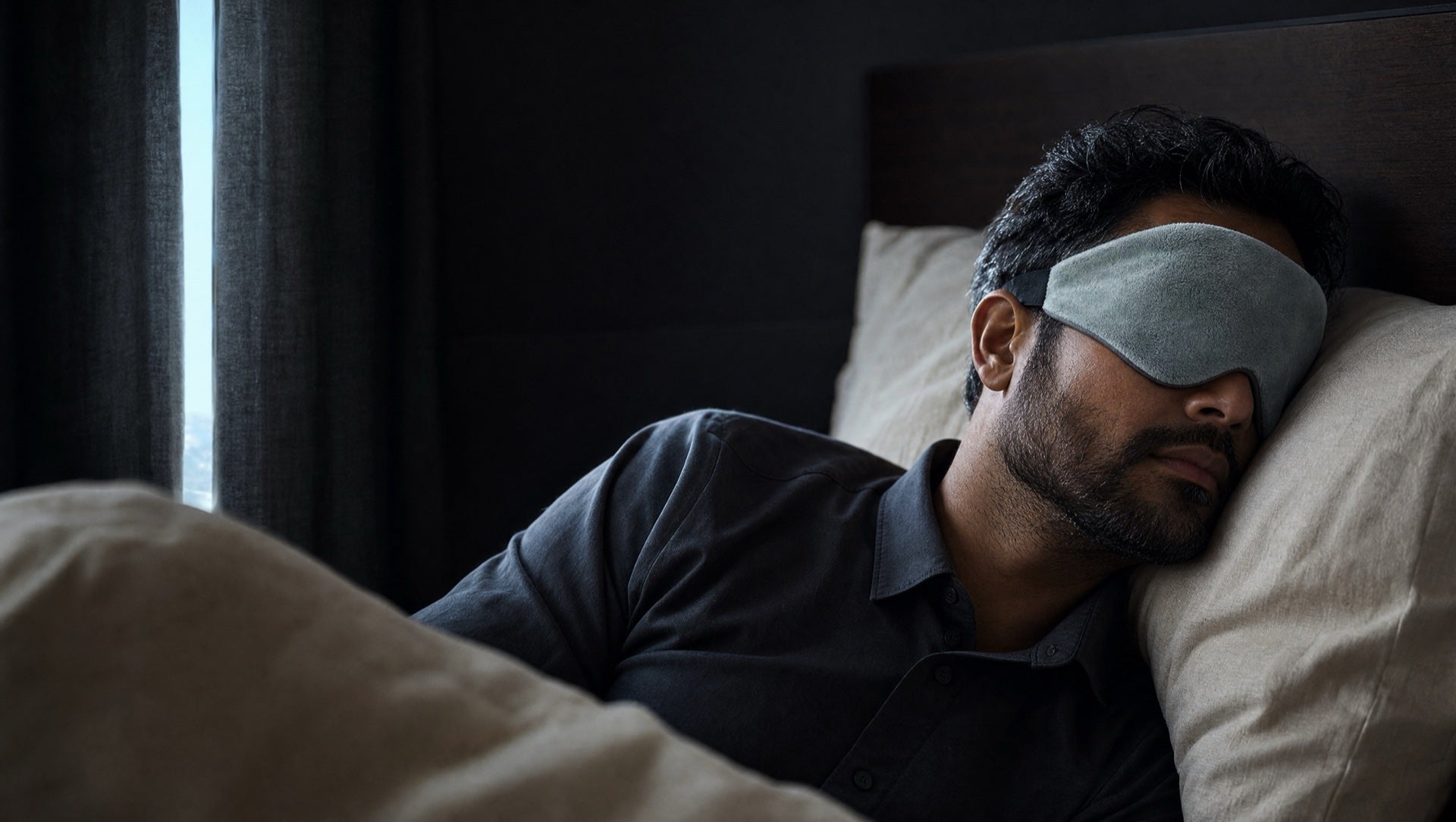 Night-shift worker resting after sunrise with a grey weighted eye mask